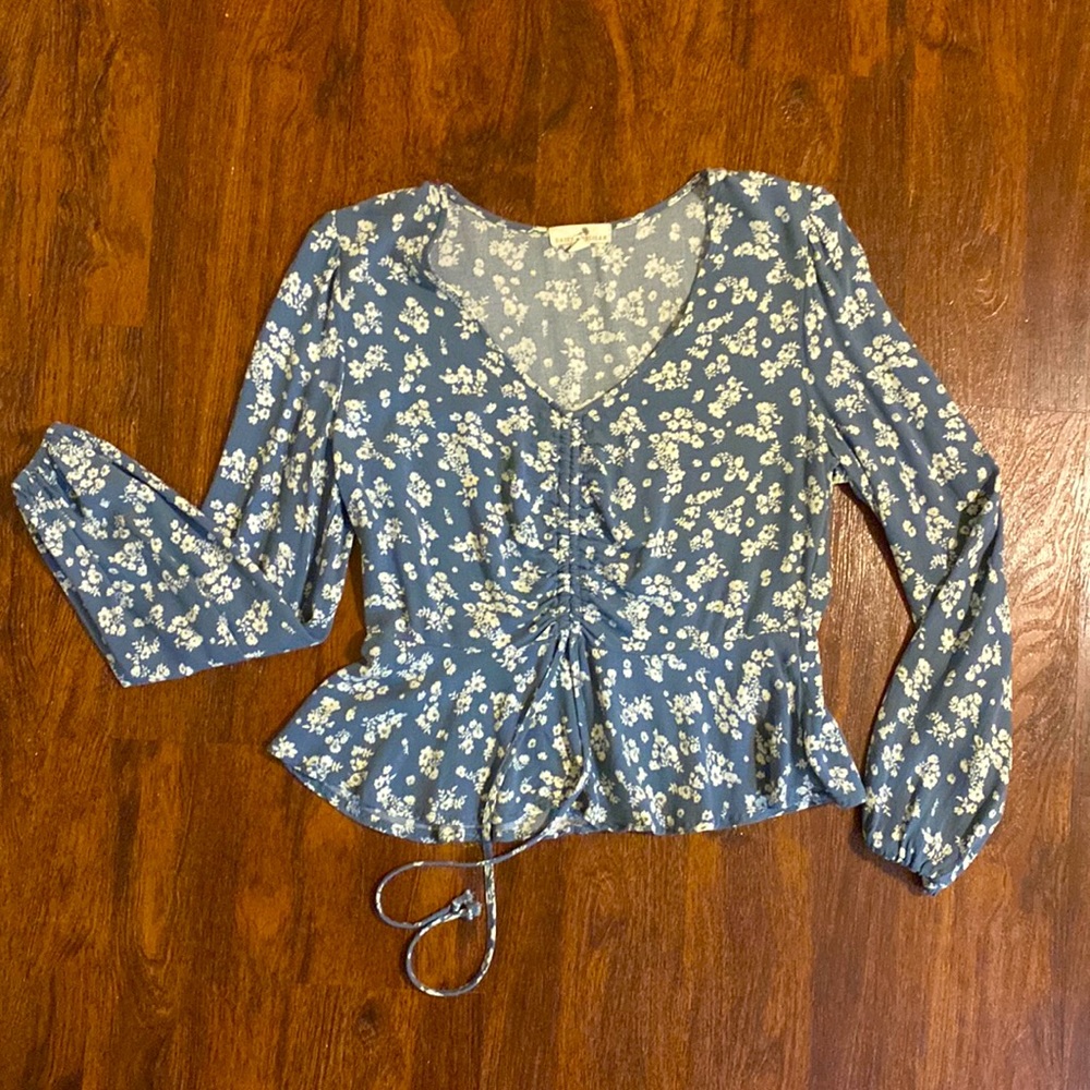 Size large long sleeve light weight top with pull strings make V neck deeper.